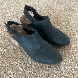 Tom’s black sueded mules